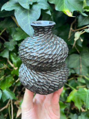 dark floating blue carved bud vase